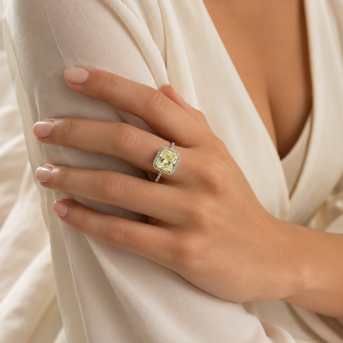 A front view of the canary emerald-cut ring with a silver-tone setting.