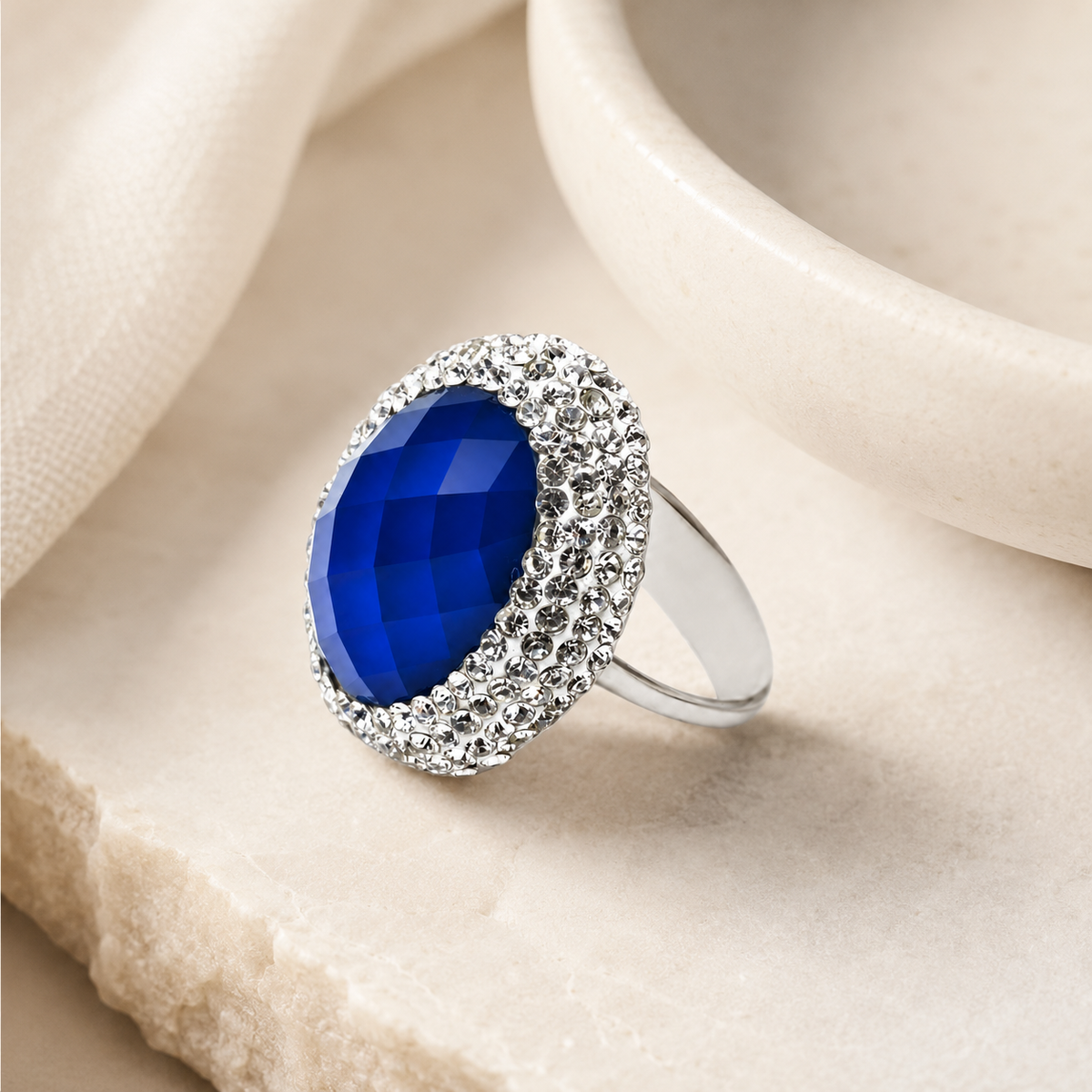 Blue statement ring with a slim band and sparkling clear details.