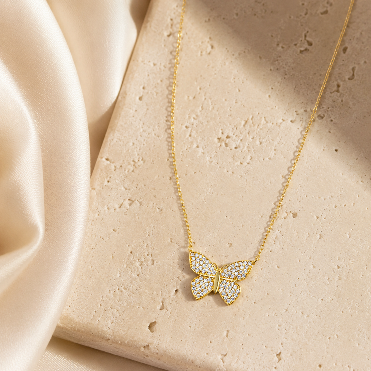 Butterfly pendant necklace with a delicate gold-tone chain.