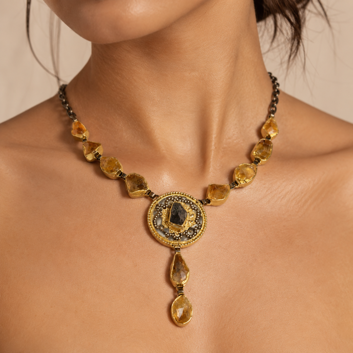 Citrine medallion drop necklace with golden stone accents and a gold-tone finish.