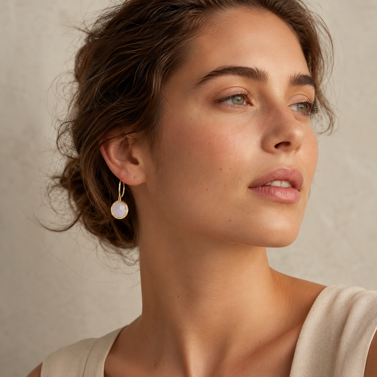 Moonstone drop earrings with a polished gold-plated frame and hook.