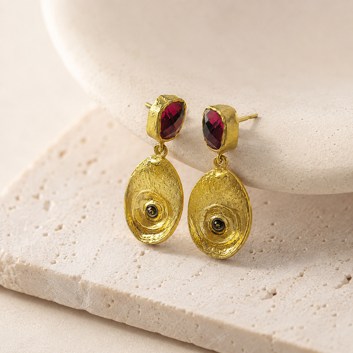 Gold-plated earrings with olive green stones and oval drop shape.