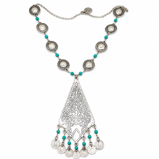 A silver-tone necklace with turquoise beads and an ornate teardrop pendant on a white background.