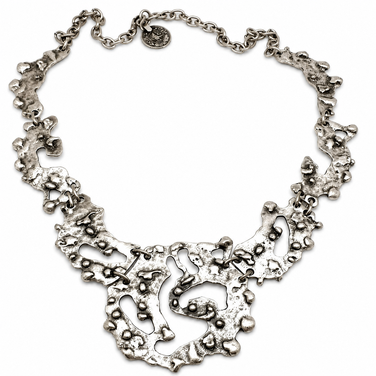 Organic silver-tone statement necklace with a sculptural pendant shape and textured finish.