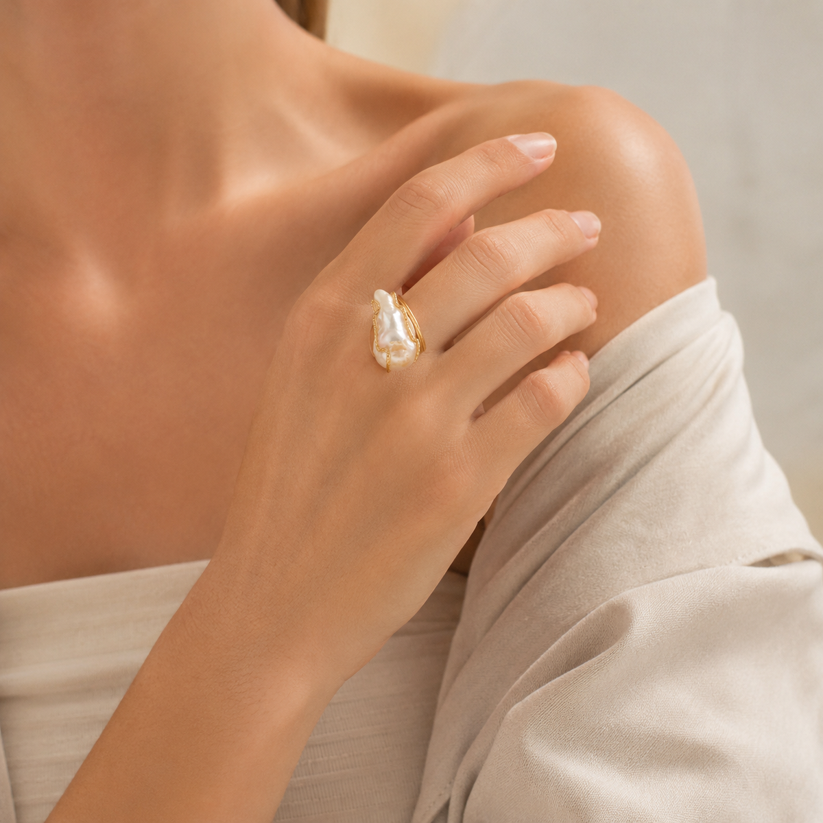Baroque pearl ring with a sculptural gold-plated setting.