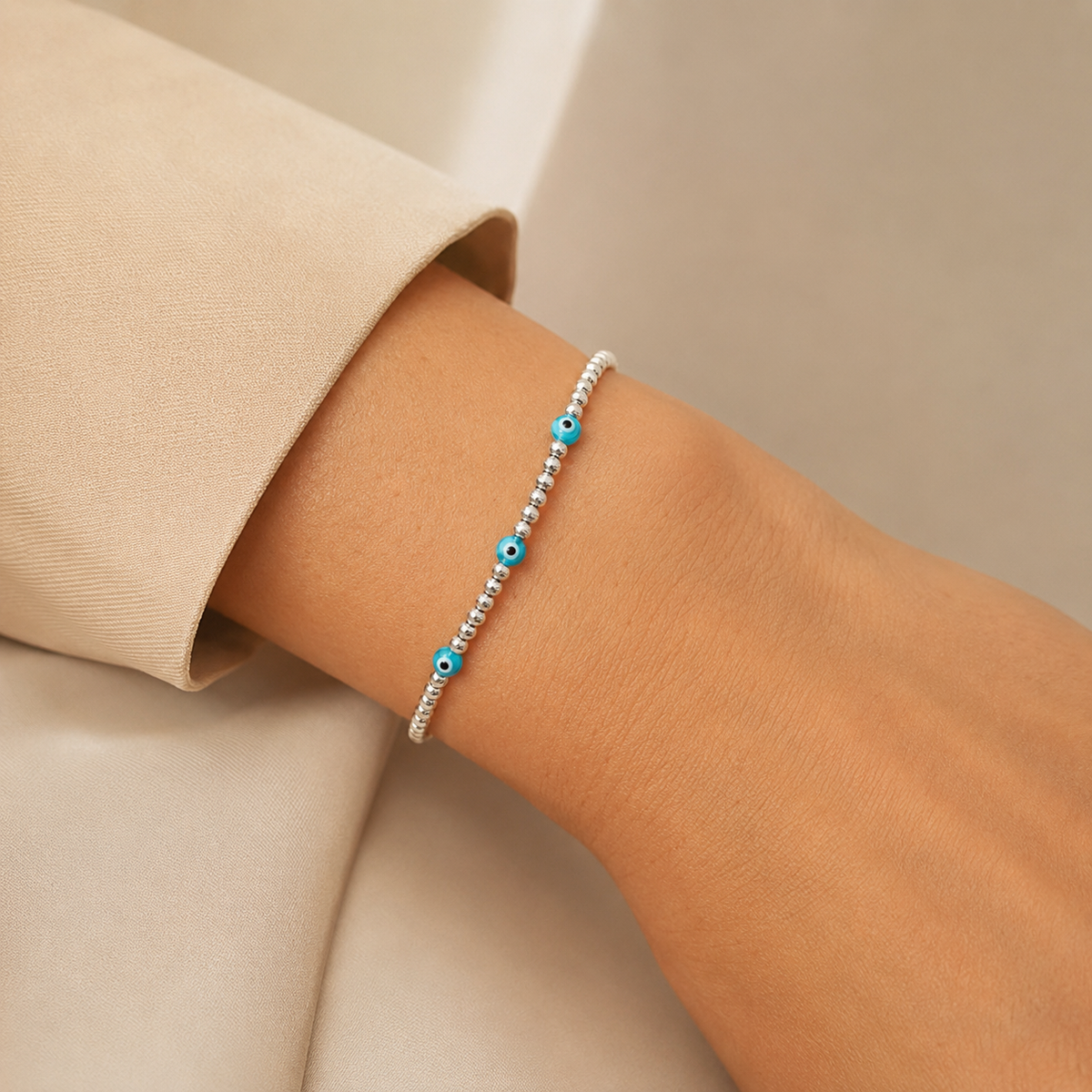 Silver-tone bracelet with blue eye details shown in a clean product view.