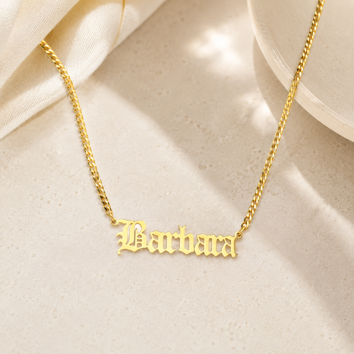 Gold-tone personalized necklace with a bold name pendant and classic chain.