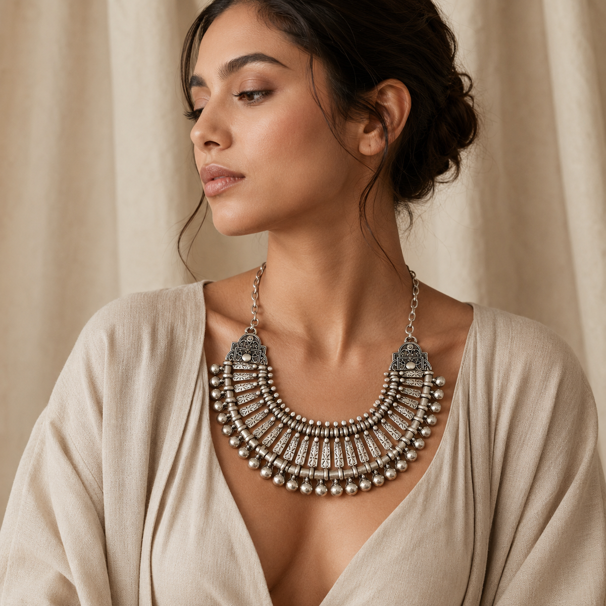 Silver-tone statement necklace with an ornate fan-inspired design.