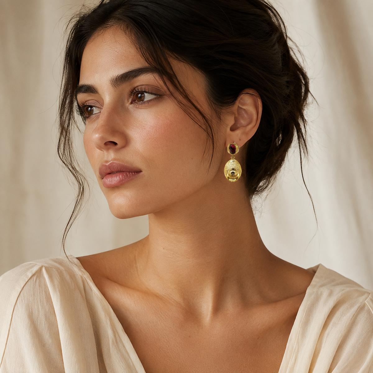 Gold-plated drop earrings with olive green stones in a polished design.