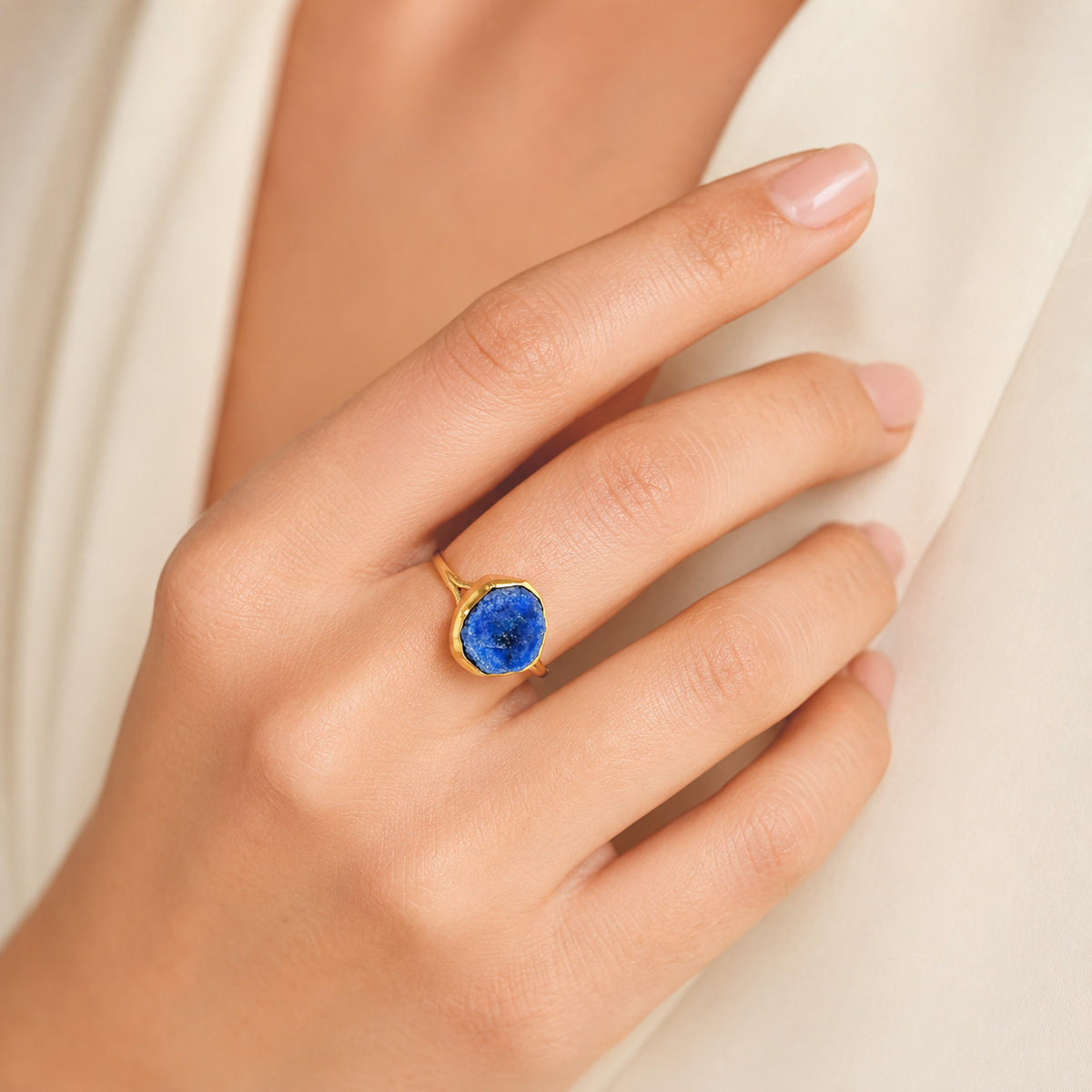 Raw lapis lazuli statement ring shown from the side.
