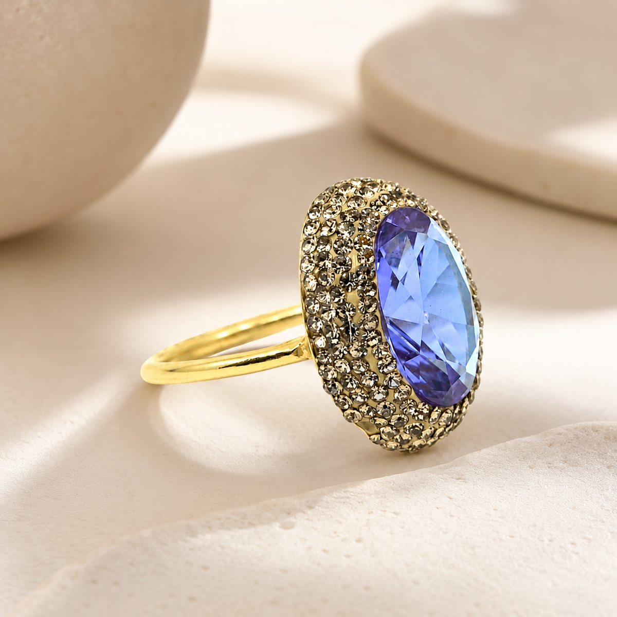 Side view of a gold-tone ring with a faceted color-changing center.