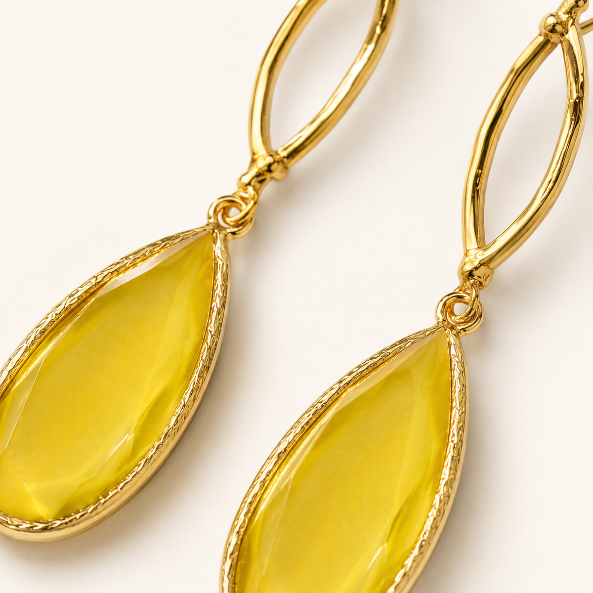 Close view of mustard teardrop stones and the gold plated setting.