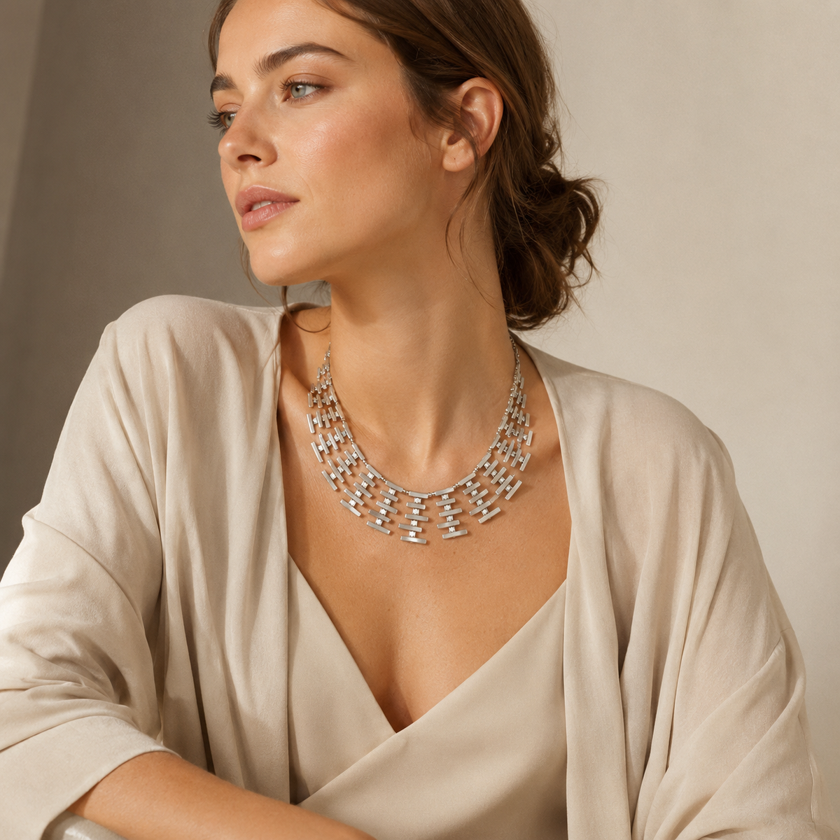Silver-tone collar necklace with a modern sculptural fringe design.