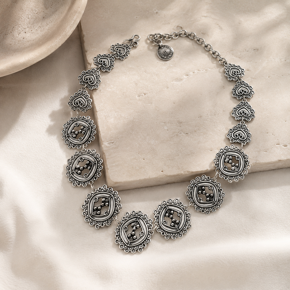 Circle cluster link necklace with a sculptural silver-tone design.