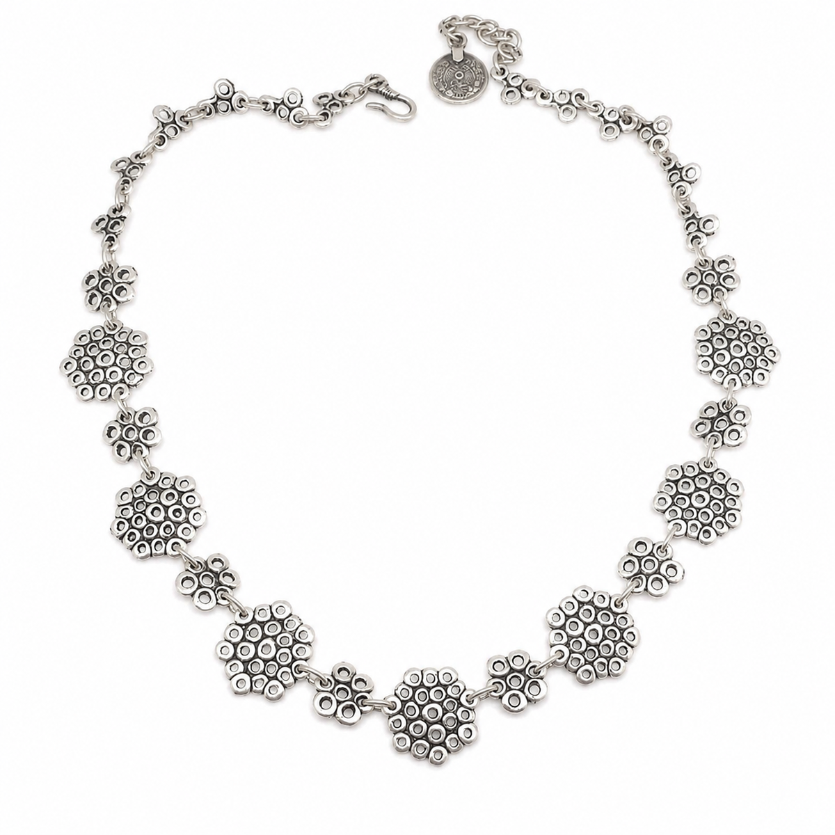 Silver-tone statement necklace with linked heart-inspired shapes on a white background.
