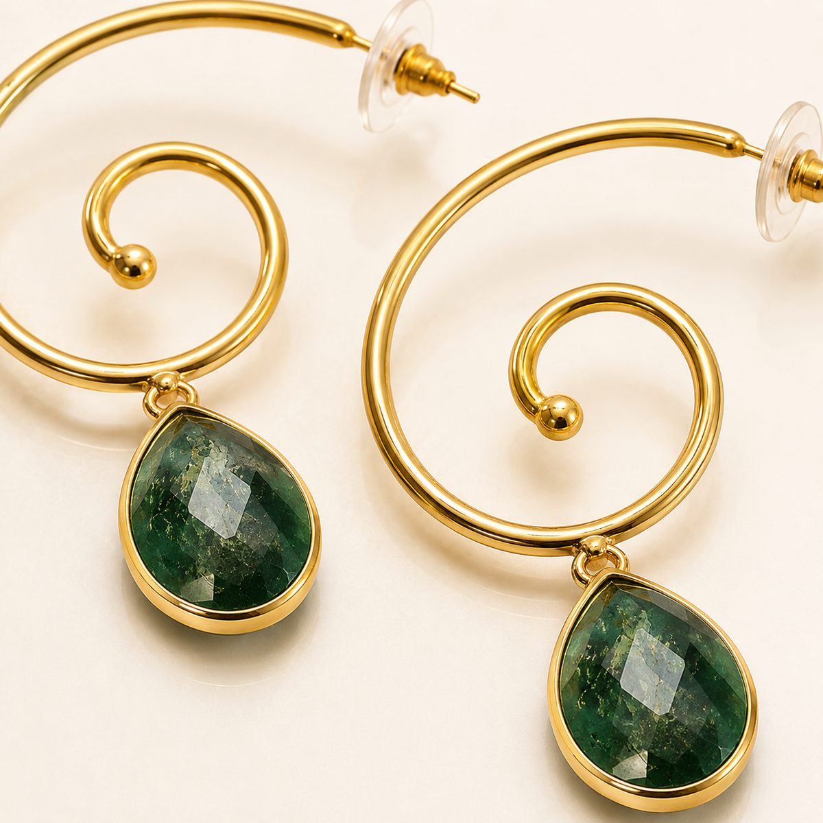 Close view of the spiral gold-plated earring and green stone drop.