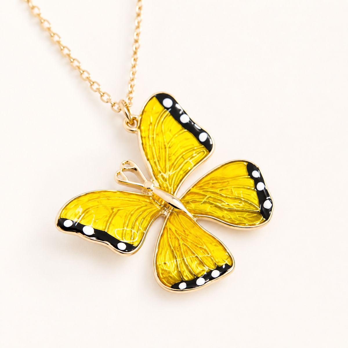 Close view of the butterfly pendant with enamel texture.