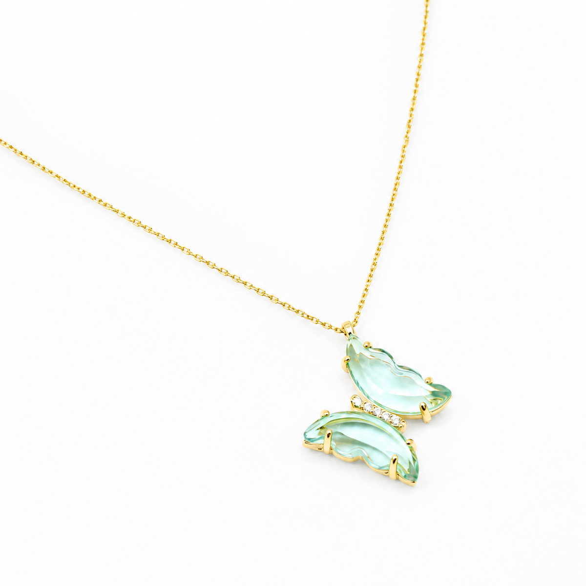 Angled view of a light blue butterfly pendant necklace.