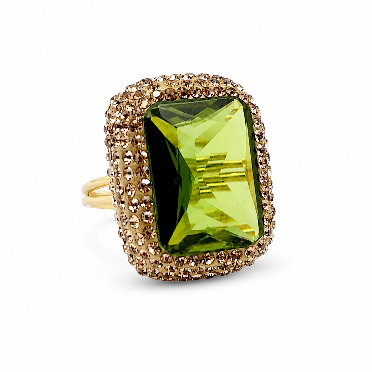 A gold-tone ring with a faceted octagon green stone and textured frame.
