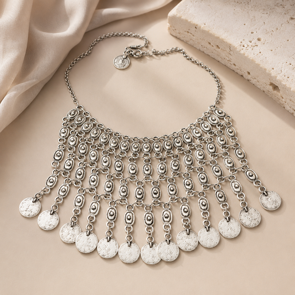 Silver-tone bib necklace with a bold layered silhouette.