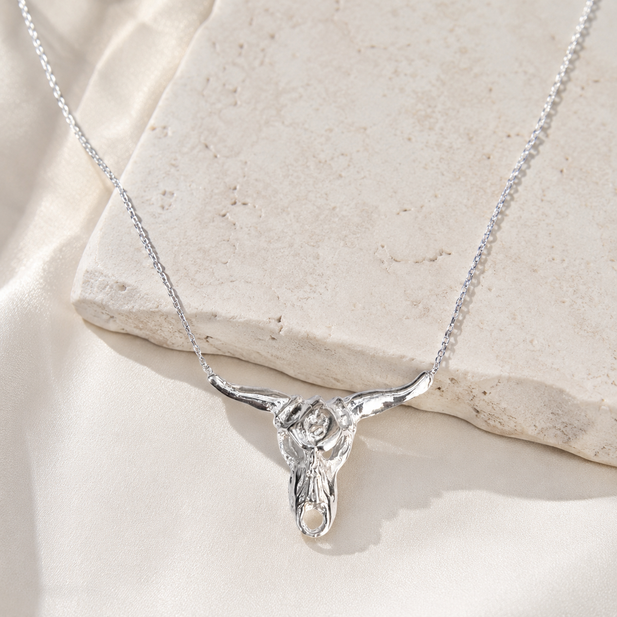 Silver-tone longhorn necklace styled as a bold pendant piece.