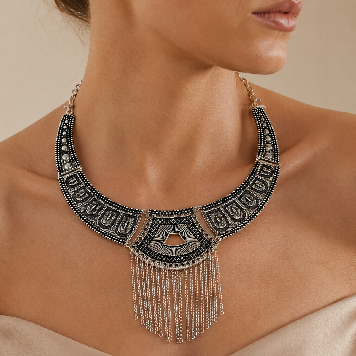 Black geometric statement necklace shown front view with silver-tone chain fringe.