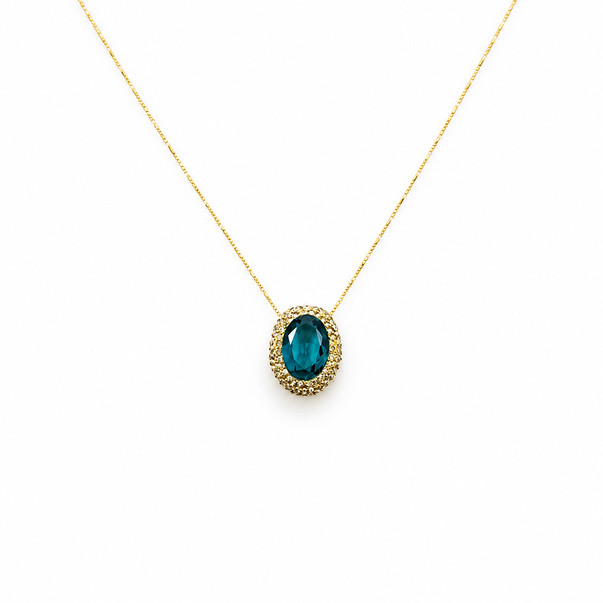 Gold-tone necklace with a green oval pendant on a delicate chain.