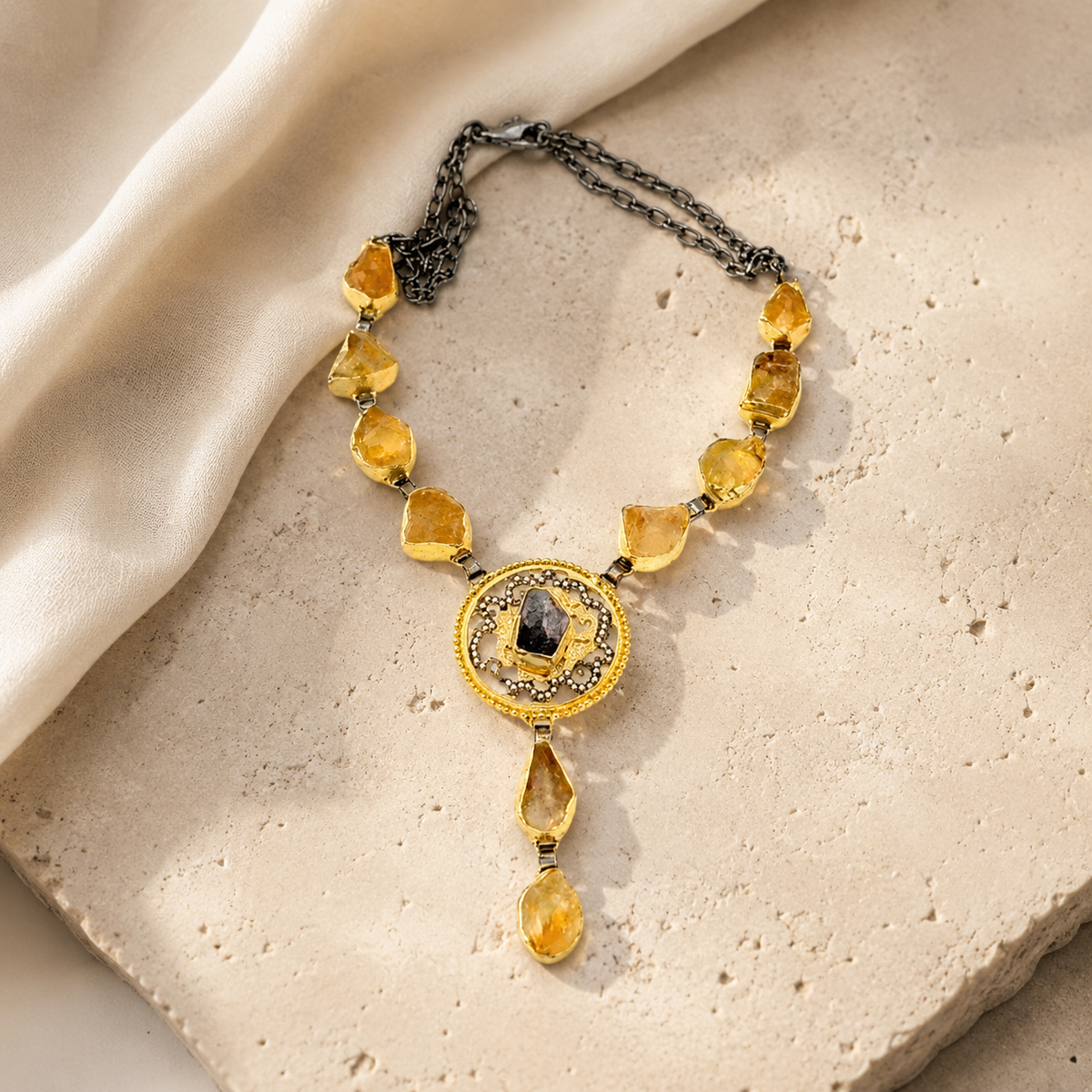 Model wearing a citrine medallion drop necklace with a warm gold-tone look.