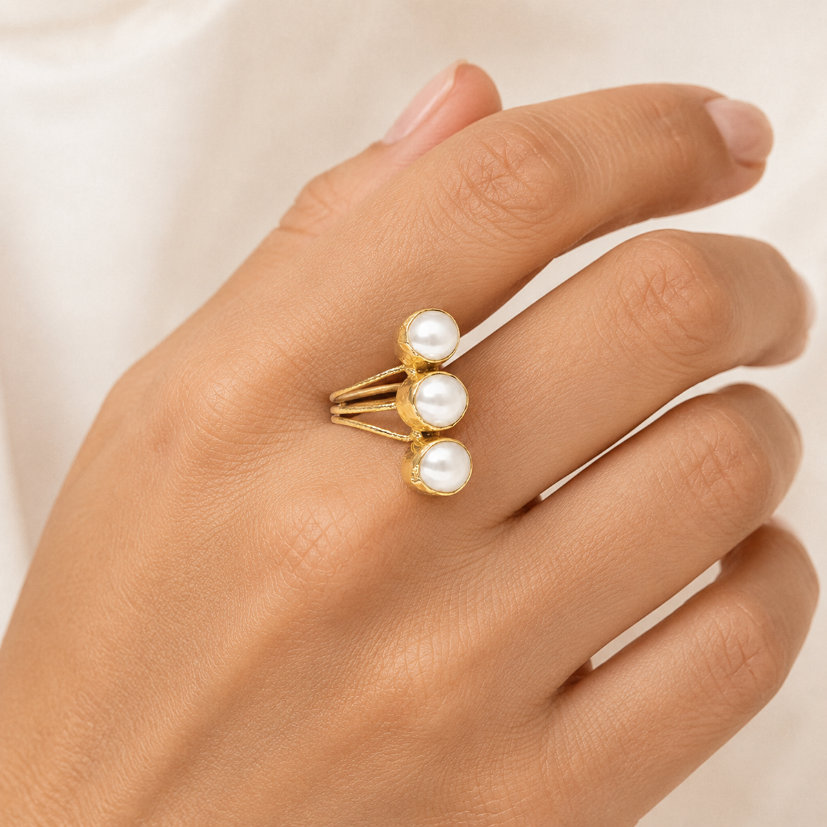 Triple pearl open wrap ring shown from the front.