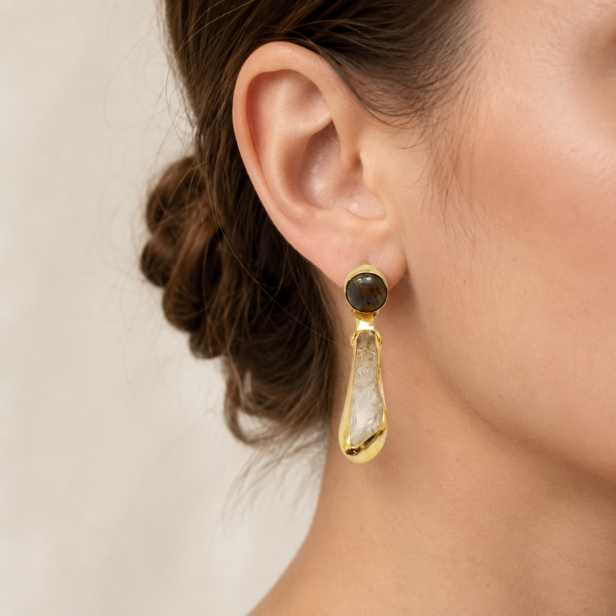 Pair of gold plated drop earrings with dark smoky quartz tops and clear quartz drops.