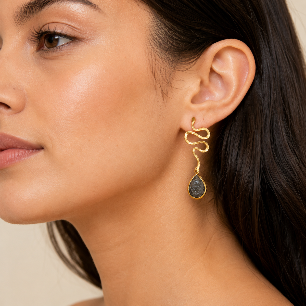 Gold-plated snake shape dangle earrings shown front view with teardrop drops.
