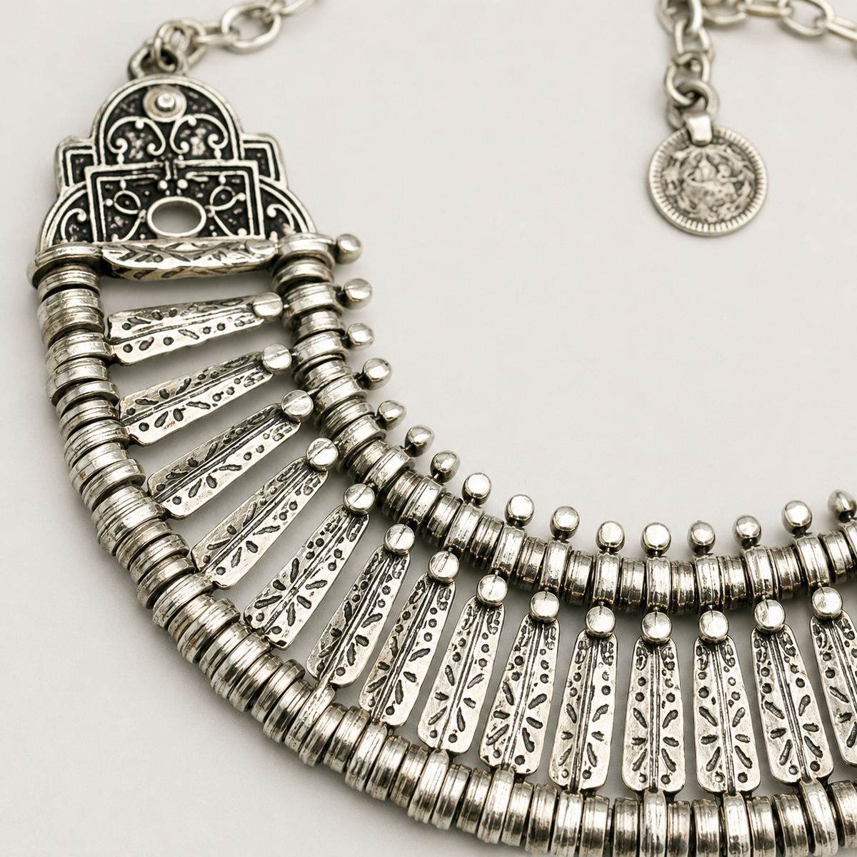Close view of the necklace's textured fan-shaped details