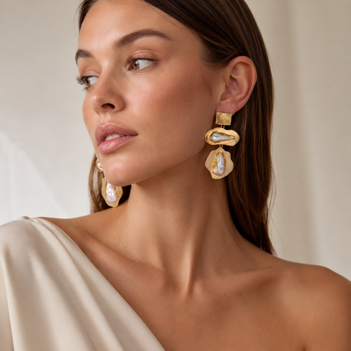 Baroque pearl drop earrings with a bold gold-plated design.