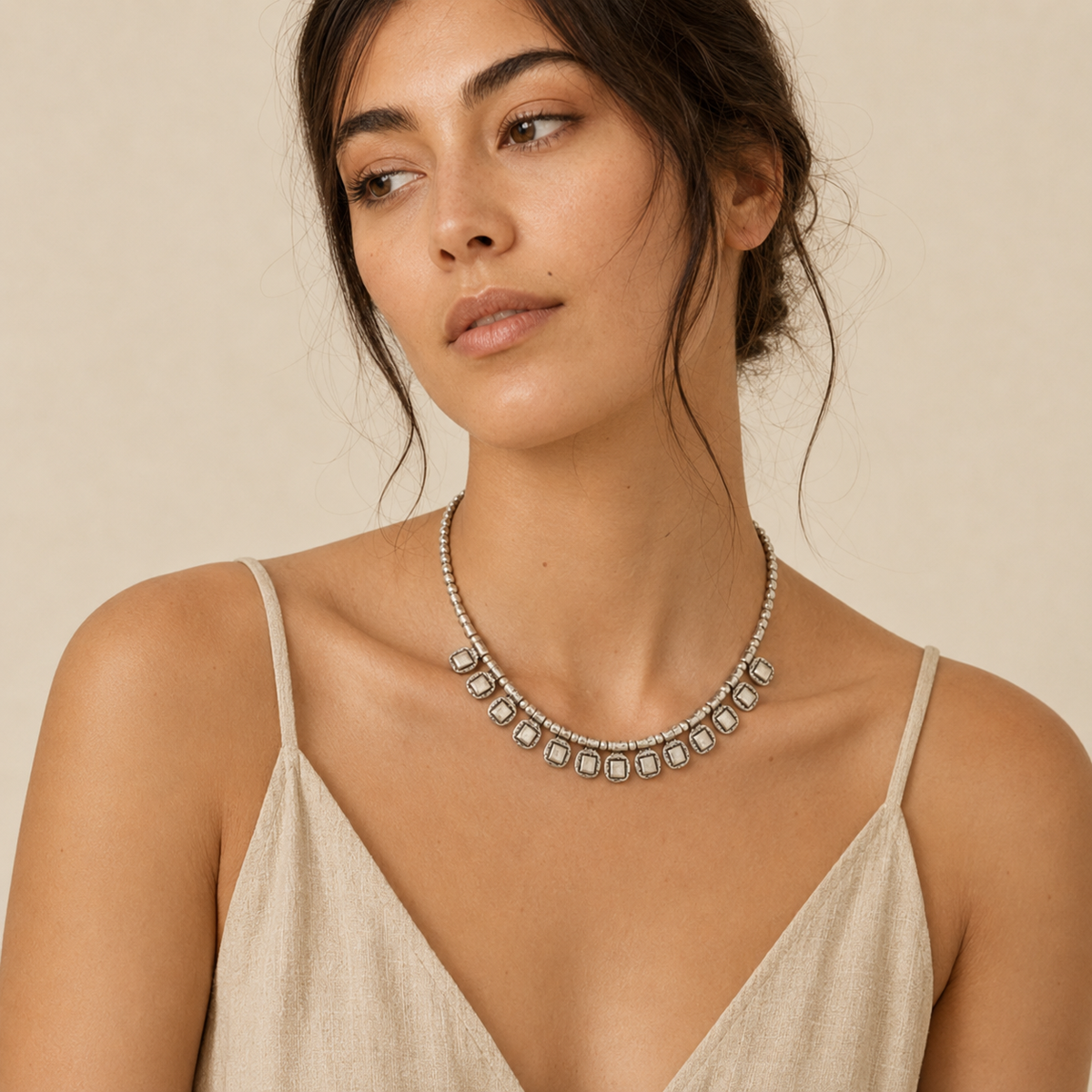Silver-tone beaded necklace with square drop accents and a modern silhouette.