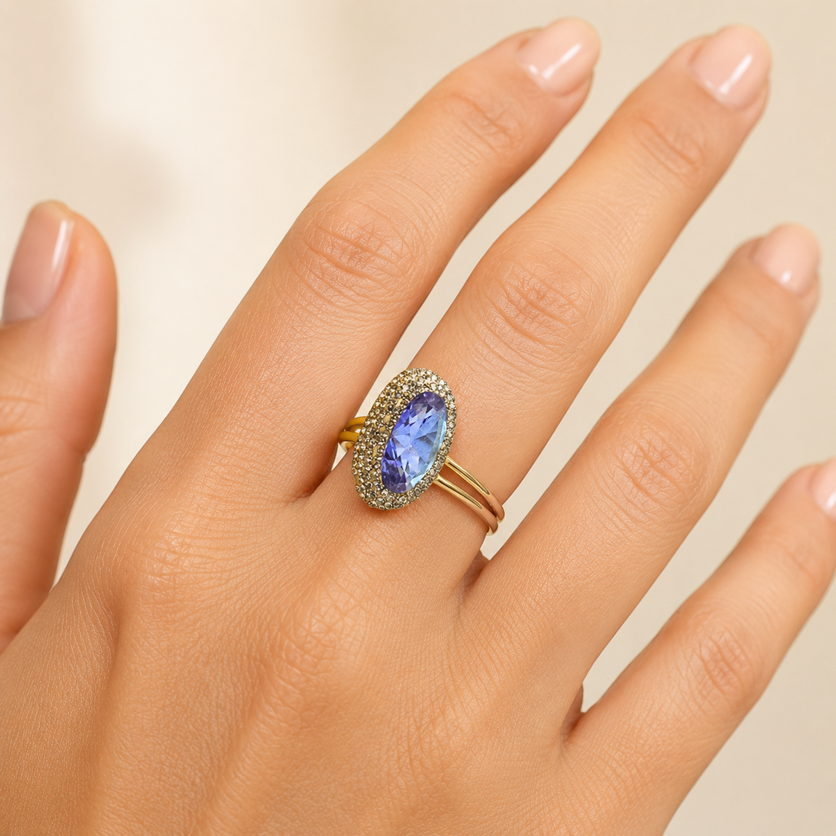 Gold-tone ring with a faceted color-changing center and sparkling trim, shown at an angle.