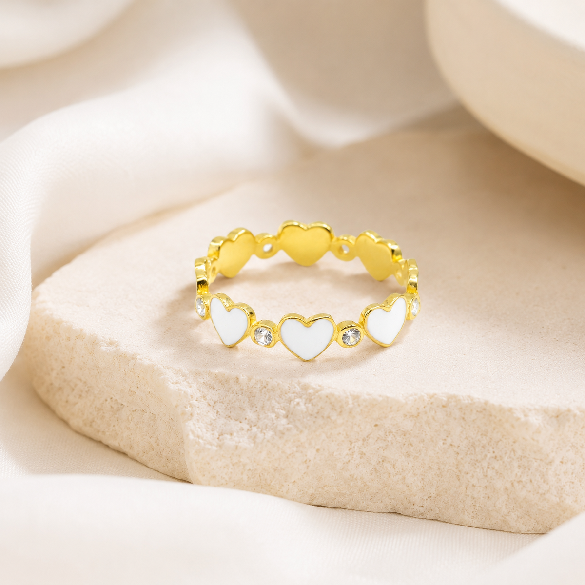Gold heart stacking ring with a polished finish.