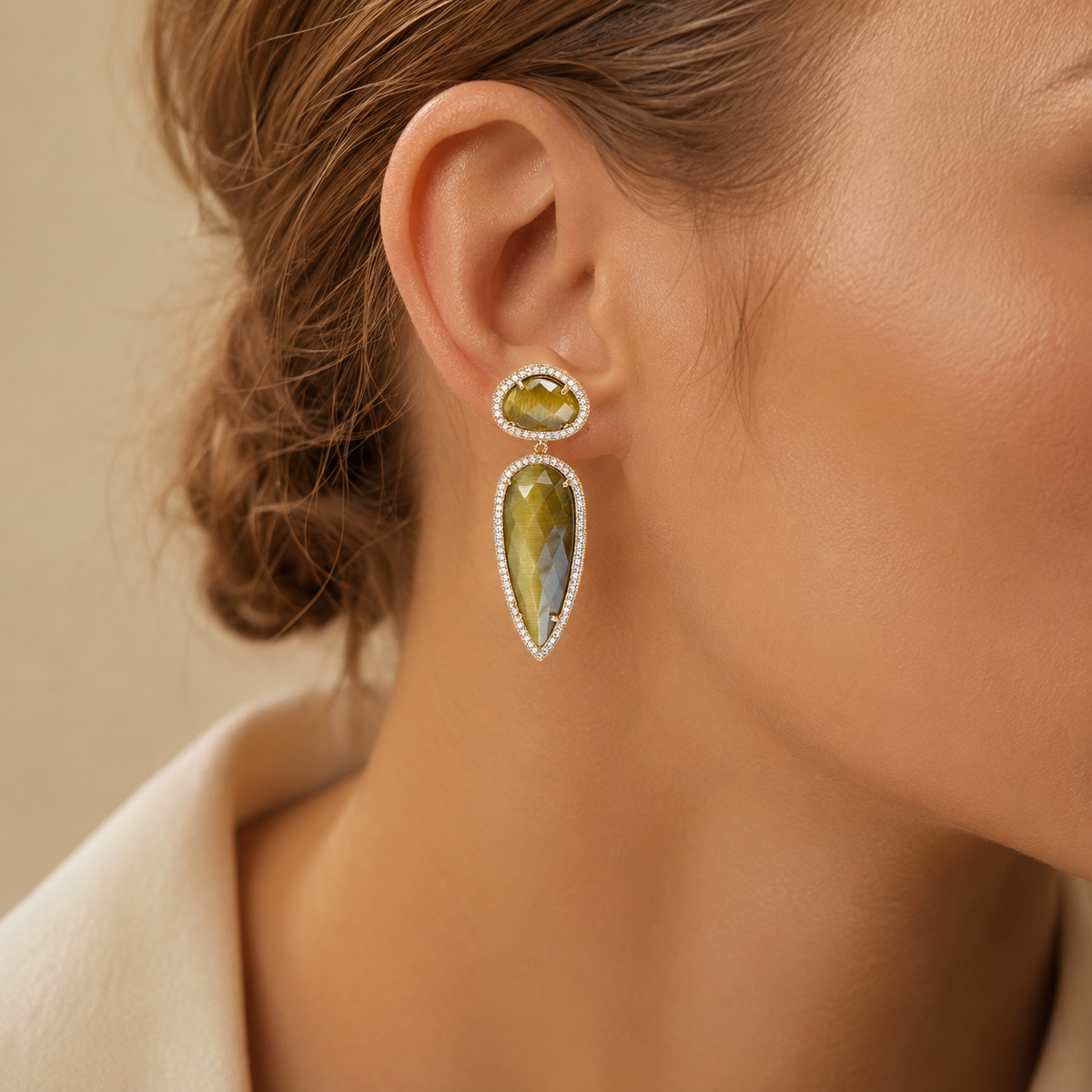 Pair of olive cat eye teardrop earrings shown front view on a white background.
