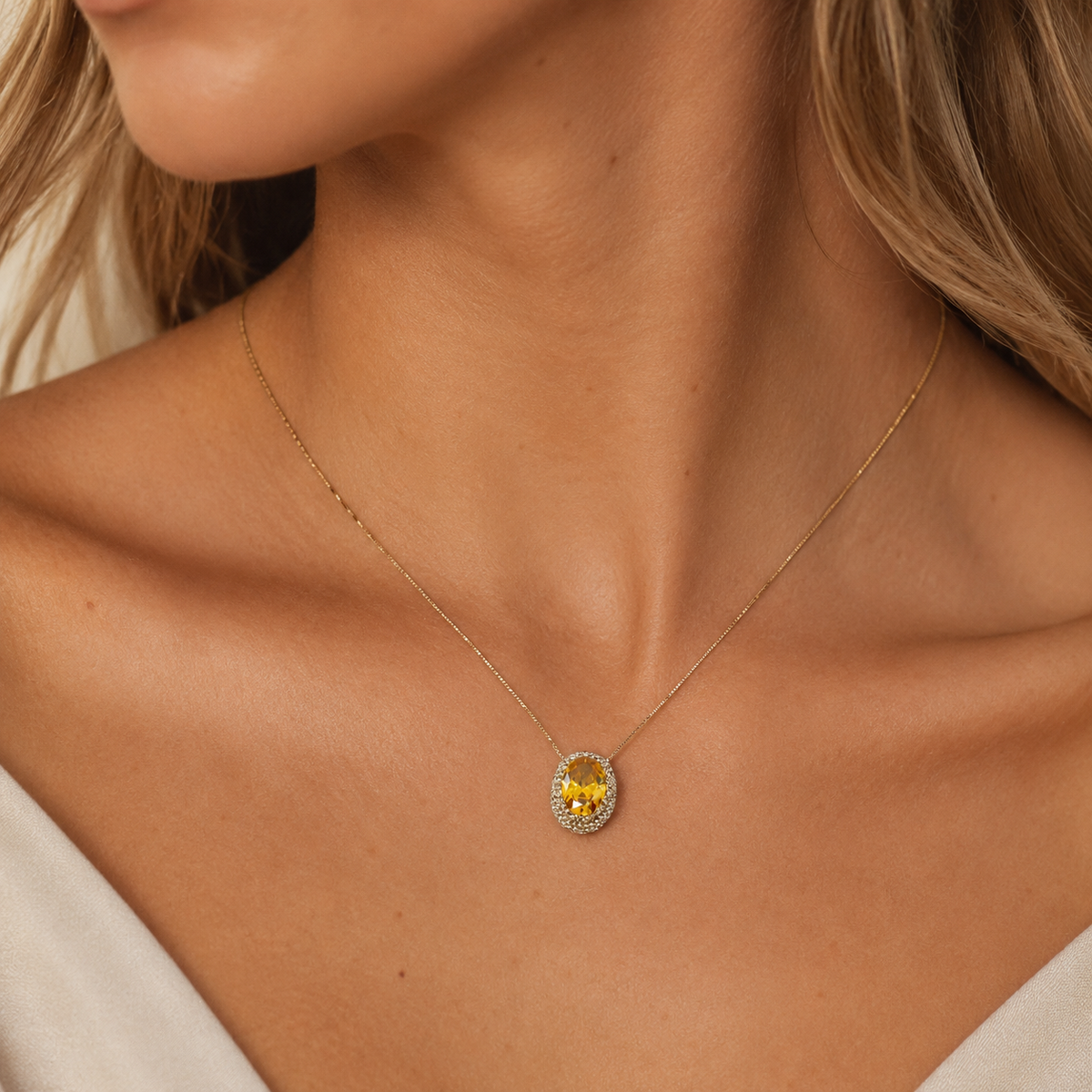Gold-tone necklace with an oval citrine pendant shown front view.