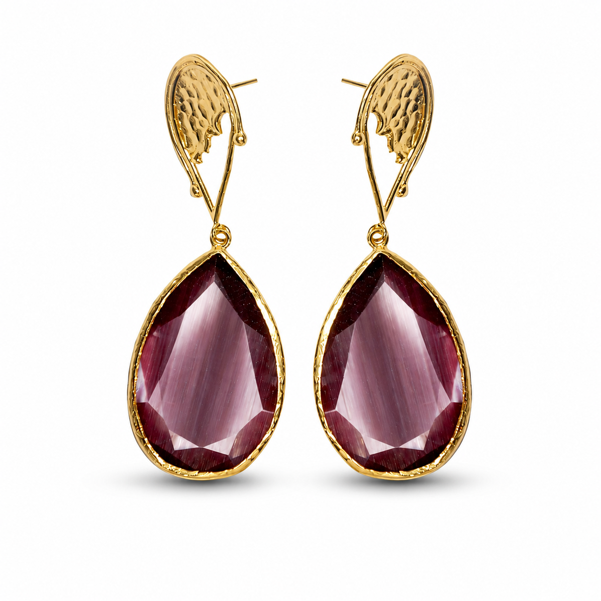Close-up of a purple teardrop stone and gold-plated setting.