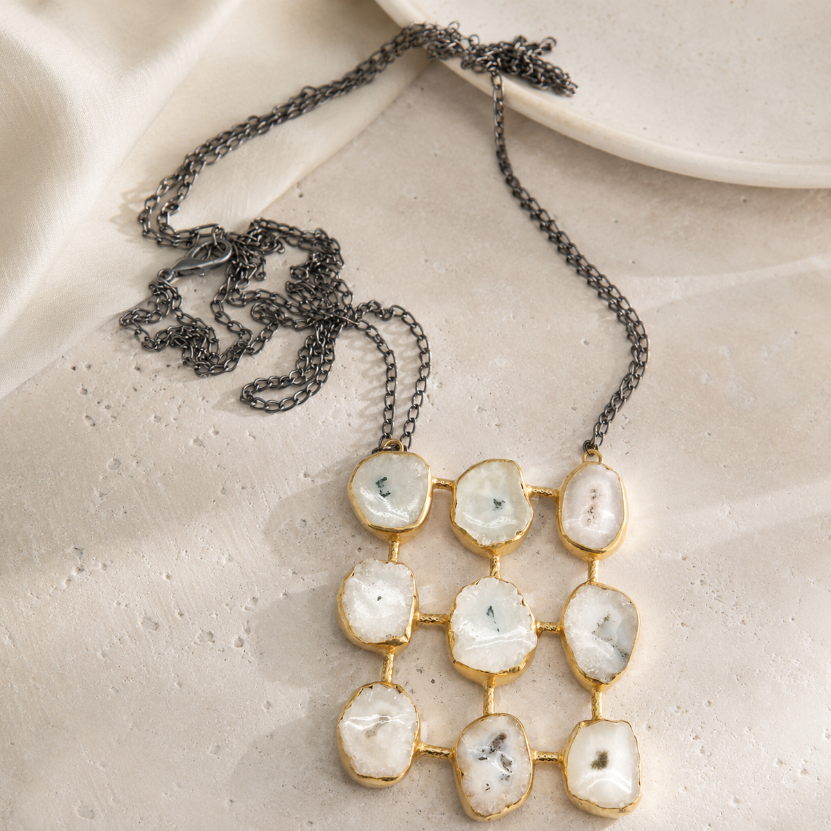 Quartz-like grid pendant necklace with a dark chain and gold-tone finish.