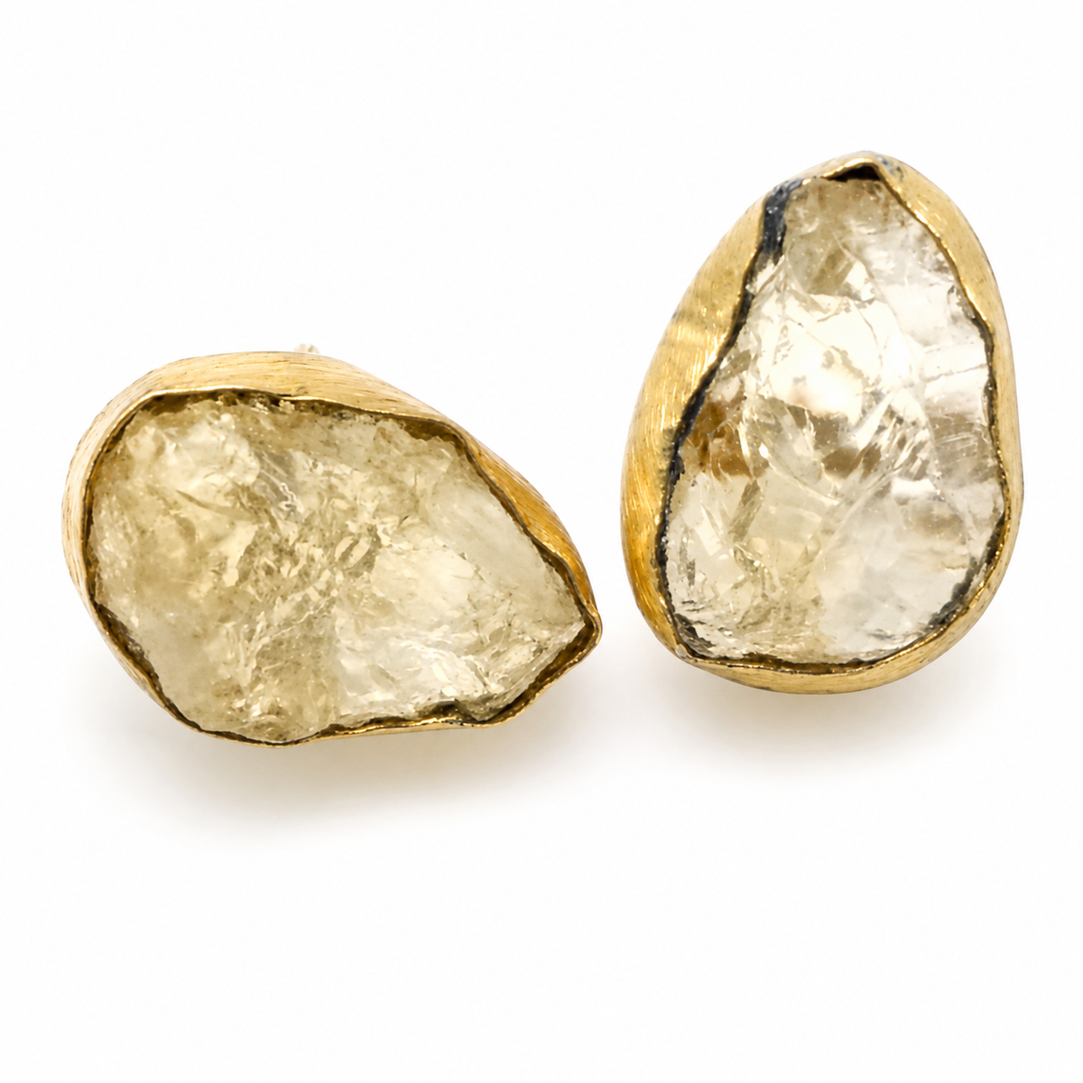 Raw quartz stud earrings with a gold-plated setting and organic shape.