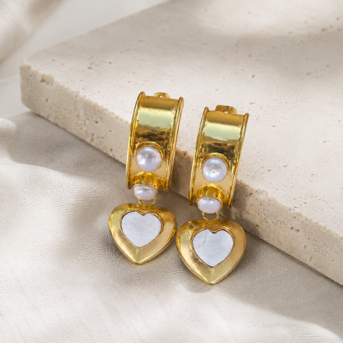Gold-plated heart charm earrings with a polished finish.