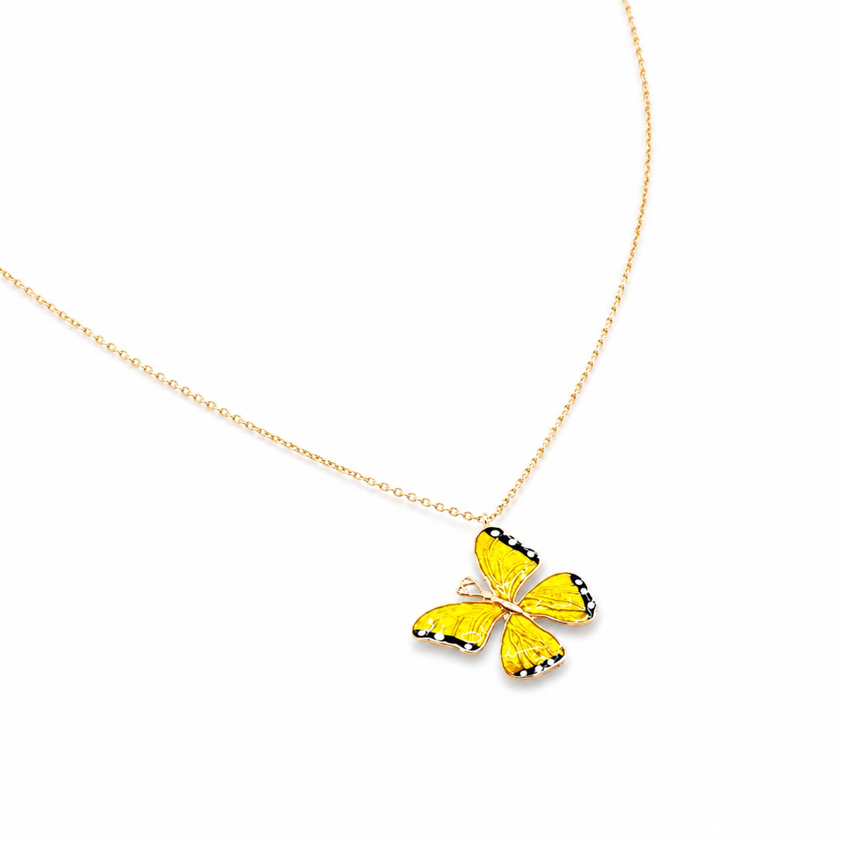 Angled view of a yellow enamel butterfly necklace.