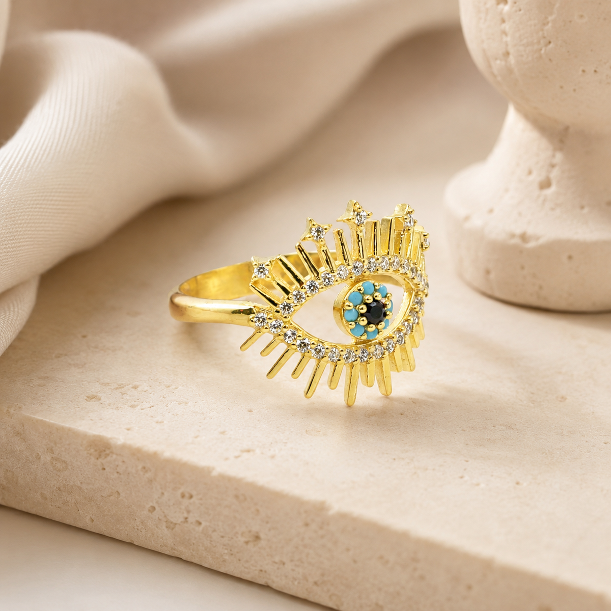 Gold-tone evil eye ring with a striking eye-shaped design.