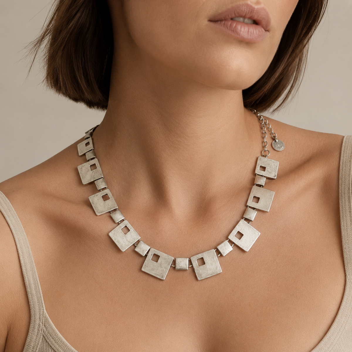 Silver-tone geometric square statement necklace shown on a white background.