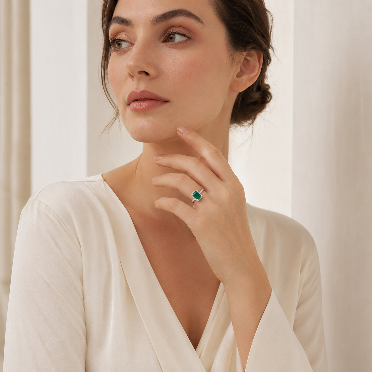 Emerald cut ring with a bright green stone and polished accents.