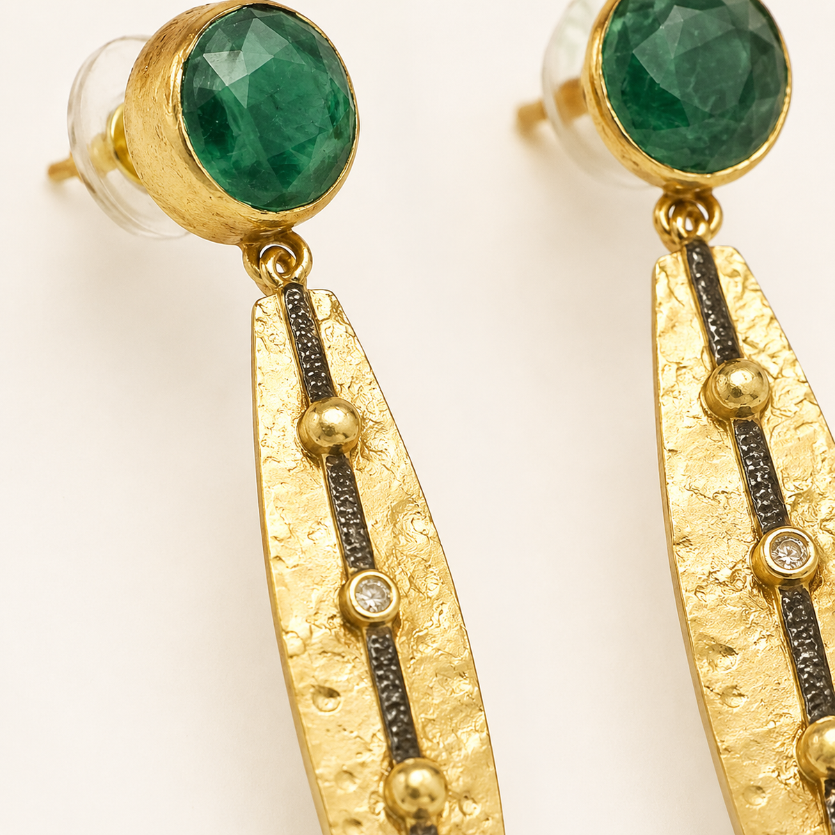 Close view of the green stone top and textured gold bar detail.