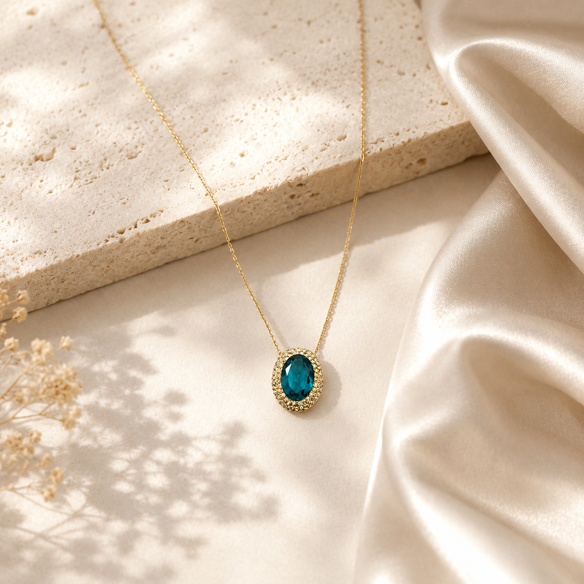 Gold-tone pendant necklace with a deep green oval stone.