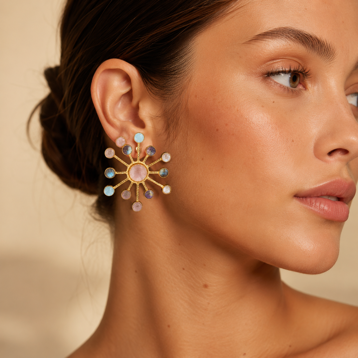 Pair of starburst statement earrings with multicolor gemstone-style accents and a gold-plated look.