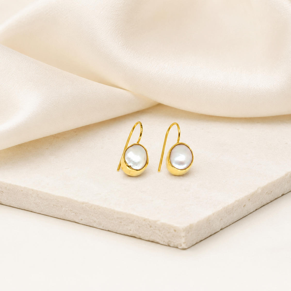 Mother of pearl drop earrings with a gold-plated finish shown on a white background.